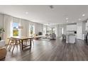 Open-concept living area featuring a dining space, modern furnishings, and abundant windows at 12199 Xavier Ave, Port Charlotte, FL 33981