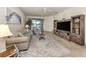 The well-lit living room features comfortable seating, stylish décor, and sliding door access to outdoor space at 12515 Felice Dr, Venice, FL 34293