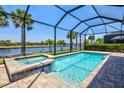 Beautiful screened-in pool and jacuzzi overlooking a serene lake at 13202 Borrego St, Venice, FL 34293