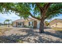 A charming single-story home featuring beautiful stone accents, a garage, and a well maintained lawn at 13648 Clara Ln, Port Charlotte, FL 33981