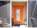 Close up of the front door with ornate glass and bright orange trim at 14124 Kewanee Ln, Port Charlotte, FL 33981