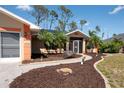 The inviting exterior features palm trees and manicured landscaping with a walkway leading to the front entrance at 14124 Kewanee Ln, Port Charlotte, FL 33981