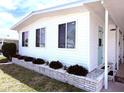 Home with a well-maintained yard and brick accents, showcasing the home's curb appeal at 175 Palm Harbor Dr, North Port, FL 34287