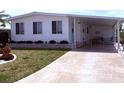 Inviting home with manicured lawn, brick accents, and a covered carport for convenient parking at 175 Palm Harbor Dr, North Port, FL 34287