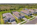 Community aerial view showing homes and lush green space along with a pond in the background at 17515 Jadestone Ct, Venice, FL 34293