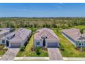 Beautiful aerial view of the home, showing roof, landscaping, driveway, and proximity to other homes at 17515 Jadestone Ct, Venice, FL 34293