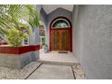 Ornate wooden double front doors with arched transom window, stylish and inviting entrance at 181 S Auburn Rd, Venice, FL 34292