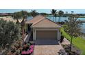 Charming home featuring a two-car garage, tile roof, and meticulously landscaped front yard at 19240 Isadora St, Venice, FL 34293