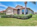 A well-maintained home featuring a lush lawn and neatly trimmed bushes, offering great curb appeal at 20246 Pezzana Dr, Venice, FL 34292