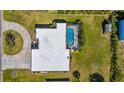 Aerial view of the home showing the pool, backyard, and circular driveway at 205 Cavallini Dr, Nokomis, FL 34275