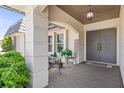 Cozy covered front porch with seating and decorative welcome sign at 205 Cavallini Dr, Nokomis, FL 34275