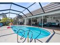 Screened-in pool with a covered patio with comfortable seating and dining area at 205 Cavallini Dr, Nokomis, FL 34275