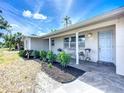 Beautifully landscaped front porch with tiled patio and seating, perfect for relaxation at 2108 Lee Ln, Sarasota, FL 34231