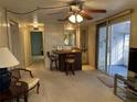Cozy living area with a wet bar, neutral carpet, and sliding glass doors to the lanai at 22 Nautical Dr, North Port, FL 34287