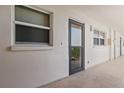 Exterior hallway featuring a storm door and windows providing natural light at 244 Saint Augustine # 605, Venice, FL 34285