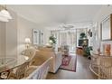 Cozy living room with elegant furnishings and sliding glass doors to an outdoor patio at 244 Saint Augustine # 605, Venice, FL 34285
