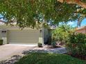 Charming home featuring an attached two-car garage and colorful landscaping at 275 Capulet Dr, Venice, FL 34292