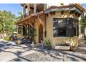 Charming home features a wood door, stucco exterior, and outdoor seating area at 2750 Gocio Road Ext, Sarasota, FL 34235