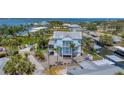 Aerial view of a waterfront home with metal roof nestled amongst palm trees and a canal nearby at 320 O Day, Englewood, FL 34223
