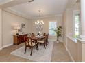 Formal dining area featuring a chandelier and neutral decor at 353 Marsh Creek Rd, Venice, FL 34292