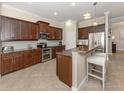 Well-equipped kitchen with stainless appliances and breakfast bar at 353 Marsh Creek Rd, Venice, FL 34292