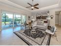 Bright living room opens to screened patio and the adjacent kitchen at 353 Marsh Creek Rd, Venice, FL 34292