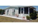 Inviting home featuring a cozy porch and a neatly landscaped yard at 358 Longwood Dr, Venice, FL 34285