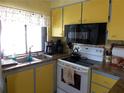 Functional kitchen area with essential appliances and lots of natural light at 358 Longwood Dr, Venice, FL 34285