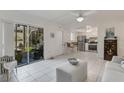 Open concept living area featuring a dining area, living room with screened-in patio, and a fully equipped kitchen at 360 Base E Ave # 413, Venice, FL 34285