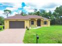 Charming single-story home featuring a brick driveway and well-maintained lawn at 431 Sevilla St, North Port, FL 34287
