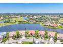 Stunning aerial view of homes, a tranquil lake, and golf course highlighting an upscale neighborhood at 4427 Blue Heron Cir, North Port, FL 34287