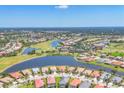 Panoramic aerial view of a golf course community, showcasing lake views and residential homes at 4427 Blue Heron Cir, North Port, FL 34287