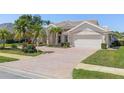 Beautiful home featuring a tile roof, two-car garage, and meticulously maintained landscaping at 511 Governors Green Dr, Venice, FL 34293