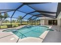 Inviting screened-in pool and spa area with views of the lush green golf course at 511 Governors Green Dr, Venice, FL 34293