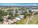 Drone photo shows tennis courts, golf course, and the home's prime location in the community at 542 Clubside Cir # 20, Venice, FL 34293