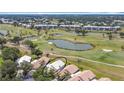 Aerial shot of property shows golf course views, community buildings, and the home's prime location at 542 Clubside Cir # 20, Venice, FL 34293