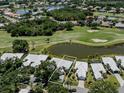 Aerial view of home with golf course and pond in backyard at 553 Fallbrook Dr, Venice, FL 34292