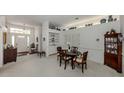 Open dining room with built-in shelving, decor, and a view of the entrance at 553 Fallbrook Dr, Venice, FL 34292
