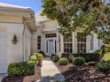 Charming front entrance with manicured landscaping and a classic exterior paint color at 553 Fallbrook Dr, Venice, FL 34292