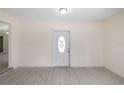 Bright entryway featuring a white front door with decorative glass and light wood-look flooring at 5992 Osprey Rd, Venice, FL 34293