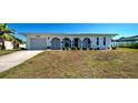Charming home at 6422 with arched entry, landscaping, and a two-car garage at 6422 Otis Rd, North Port, FL 34287