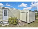 This property has a useful storage shed and is adjacent to a door and steps at 6451 Keena Ct, North Port, FL 34287