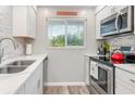 Bright kitchen featuring stainless steel appliances and white cabinetry at 649 Tamiami S Trl # 106, Venice, FL 34285
