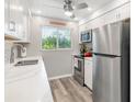 Updated kitchen with stainless steel refrigerator and modern appliances at 649 Tamiami S Trl # 106, Venice, FL 34285