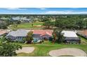 Aerial view of the house with private pool, screened in lanai and golf course behind property at 6507 Drewry'S Blf, Bradenton, FL 34203