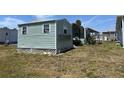 View of single-story home exterior and yard with ample outdoor space at 6765 Laurel Ct, North Port, FL 34287