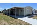 Single-story home exterior with covered parking and well-manicured lawn at 6765 Laurel Ct, North Port, FL 34287