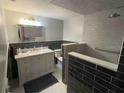 Modern bathroom featuring a tiled shower with a built-in bench and vanity at 751 Arabian Cir, Nokomis, FL 34275