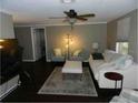 A well-lit living room with dark flooring and neutral colored decor at 751 Arabian Cir, Nokomis, FL 34275