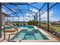 Relaxing screened-in pool and spa area with views of the lake and golf course, perfect for outdoor enjoyment at 872 Macaw Cir, Venice, FL 34285